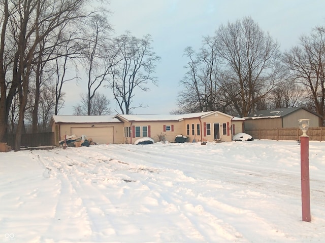 snow covered property featuring a garage