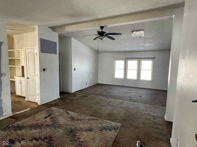 unfurnished living room featuring ceiling fan, lofted ceiling with beams, and a textured ceiling