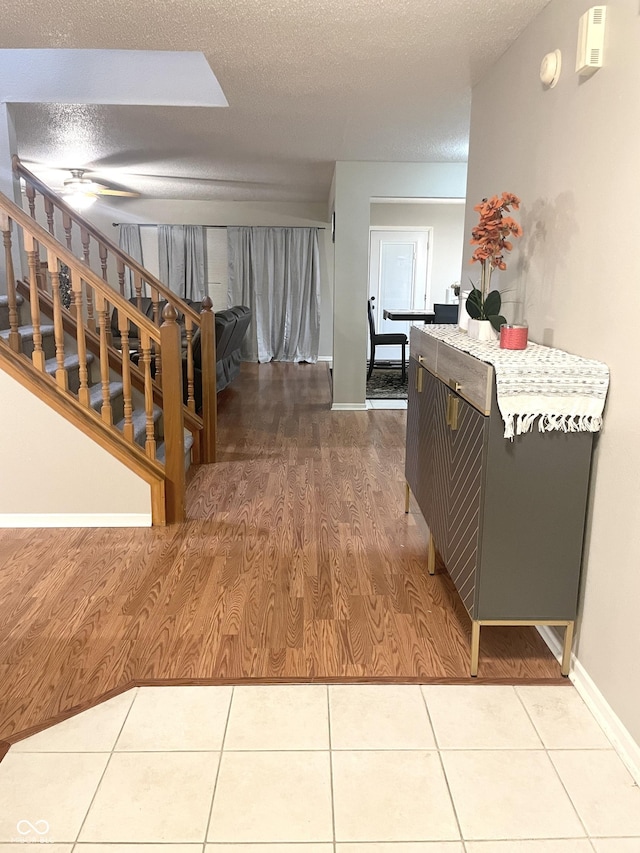 interior space featuring a textured ceiling and tile patterned floors