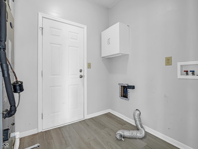 clothes washing area with washer hookup and light hardwood / wood-style floors