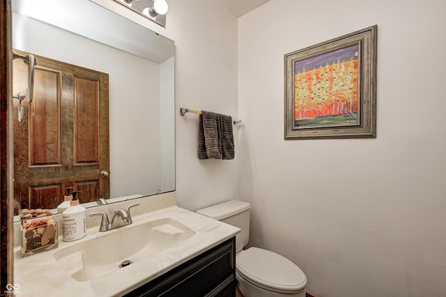 bathroom with toilet and vanity