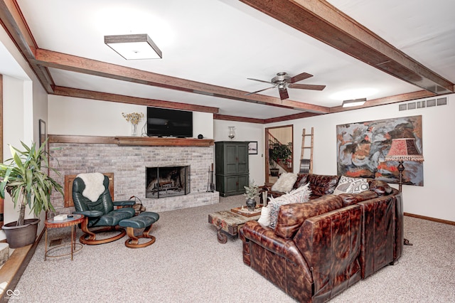 living room featuring ceiling fan, beam ceiling, light carpet, and a fireplace