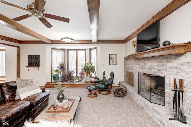 living room with carpet, ceiling fan, a fireplace, and beamed ceiling