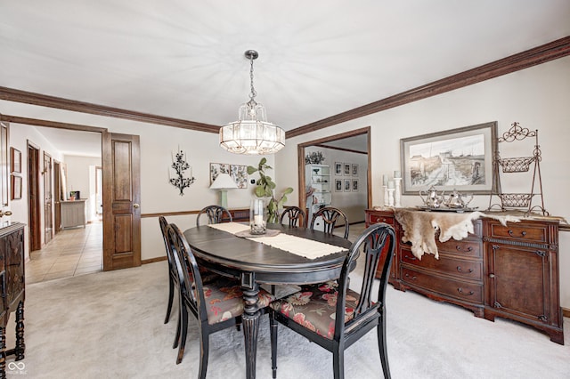 dining room featuring ornamental molding, light carpet, and an inviting chandelier