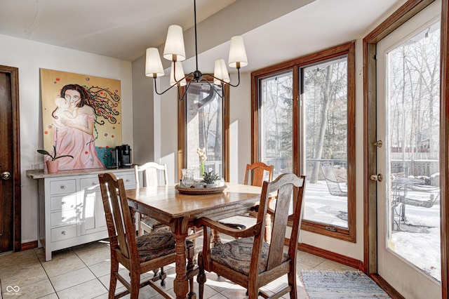 tiled dining area with an inviting chandelier