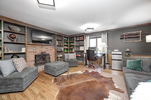 living room featuring wood-type flooring and a fireplace