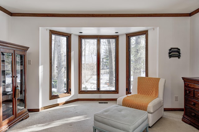 living area with light colored carpet and crown molding