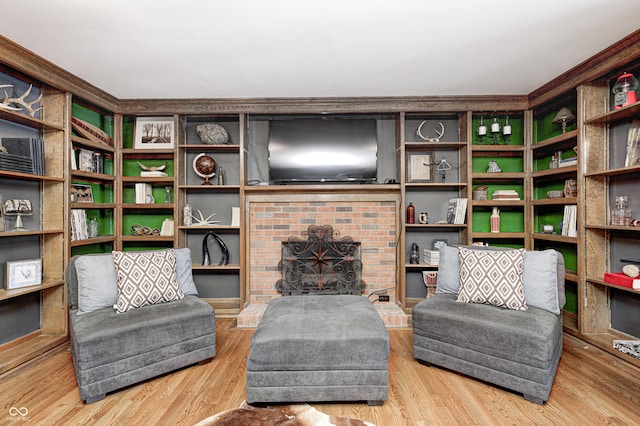 living area with a fireplace and hardwood / wood-style flooring