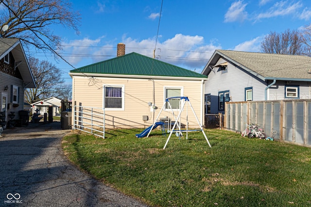 rear view of house with a yard