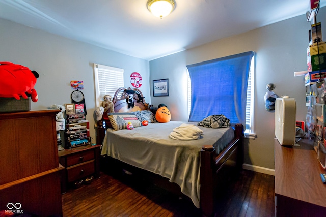 bedroom with dark wood-type flooring