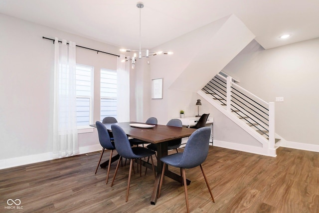 dining room with a chandelier, a wealth of natural light, and dark wood-type flooring