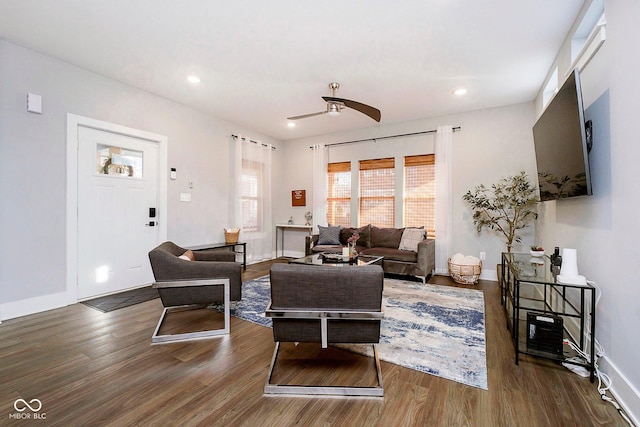 living room featuring dark hardwood / wood-style floors and ceiling fan