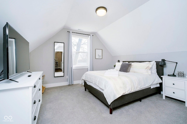 carpeted bedroom featuring lofted ceiling