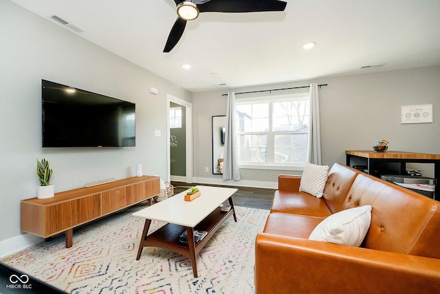 living room with hardwood / wood-style flooring and ceiling fan