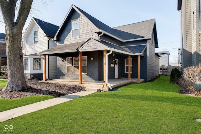 view of front of house featuring a front lawn and covered porch