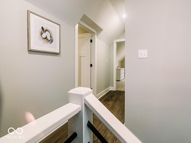 corridor featuring dark hardwood / wood-style flooring and lofted ceiling