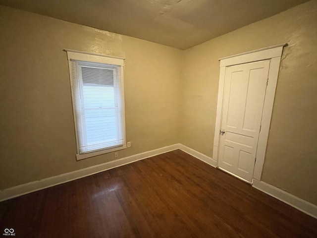 unfurnished room featuring dark hardwood / wood-style flooring