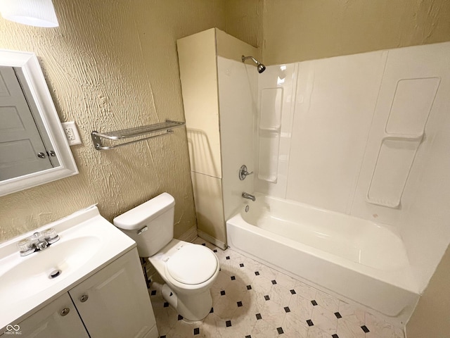 full bathroom featuring toilet, vanity, and washtub / shower combination