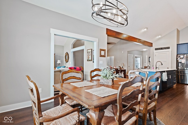 dining area with vaulted ceiling with beams, dark hardwood / wood-style flooring, sink, and a chandelier