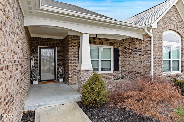 view of exterior entry with covered porch