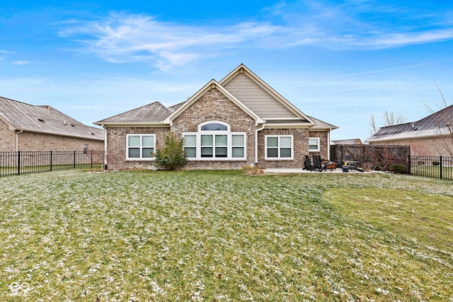 rear view of property with a yard and a patio