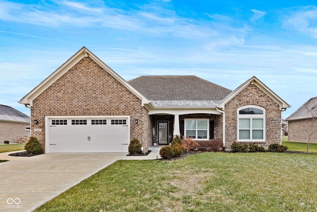 view of front of property with a garage and a front lawn