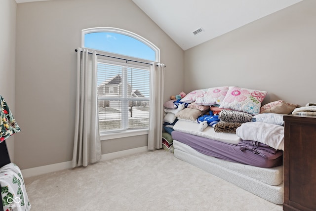 carpeted bedroom with lofted ceiling and multiple windows