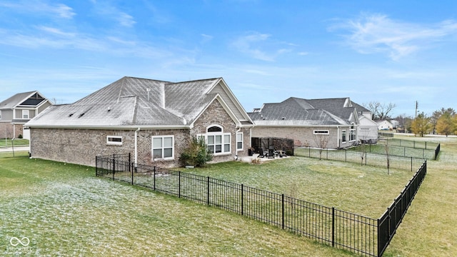 rear view of house featuring a patio area and a lawn