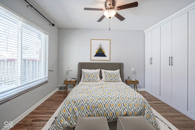 bedroom featuring a closet, ceiling fan, and dark wood-type flooring