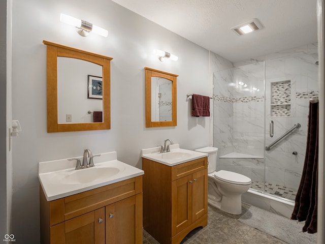 bathroom featuring toilet, vanity, a textured ceiling, and walk in shower