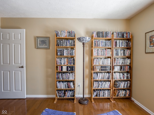 miscellaneous room with hardwood / wood-style floors and a textured ceiling