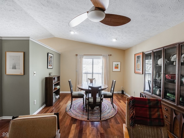 dining space with hardwood / wood-style floors, ceiling fan, a textured ceiling, and vaulted ceiling