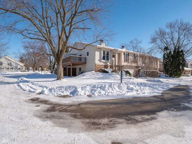 view of snow covered back of property