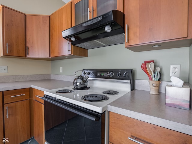 kitchen featuring electric stove and tile patterned flooring