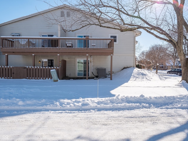 snow covered back of property with central air condition unit