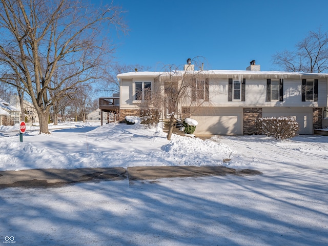 view of front of home featuring a garage and a wooden deck