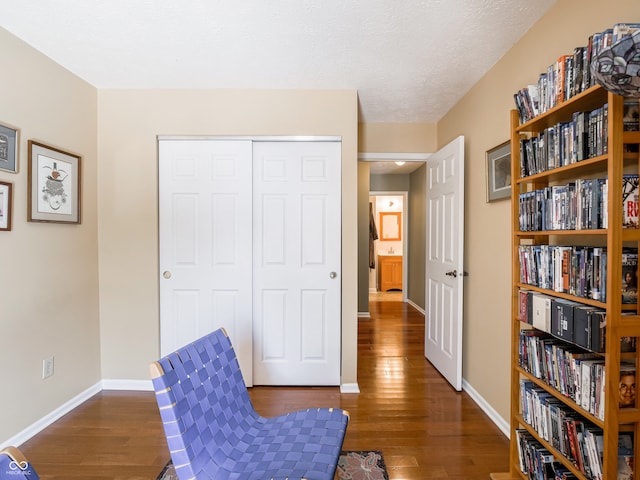 living area featuring wood finished floors and baseboards