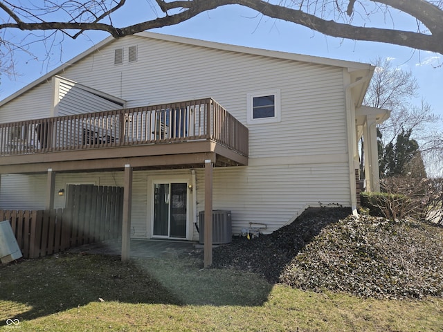 rear view of house with central air condition unit, a wooden deck, and fence