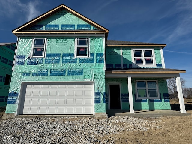 property in mid-construction with a porch and a garage