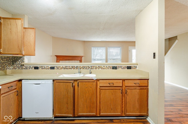 kitchen with a textured ceiling, dishwasher, decorative backsplash, dark hardwood / wood-style flooring, and sink