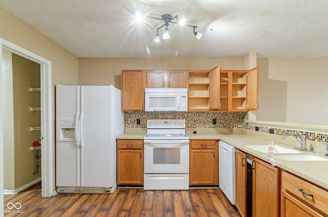 kitchen featuring white appliances, a textured ceiling, backsplash, dark hardwood / wood-style flooring, and sink