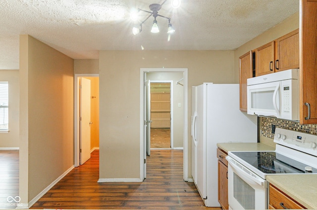 kitchen with white appliances, a textured ceiling, backsplash, and dark wood-type flooring