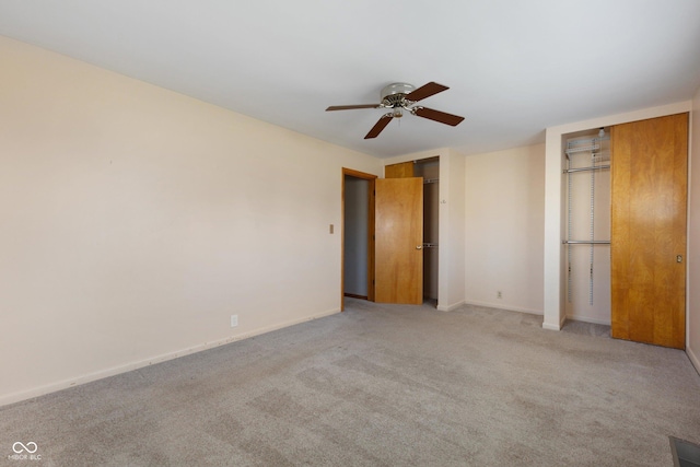 unfurnished bedroom featuring ceiling fan and light colored carpet