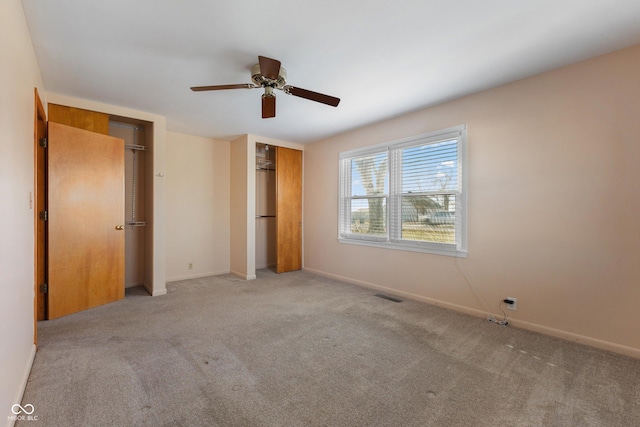 unfurnished bedroom with ceiling fan and light carpet