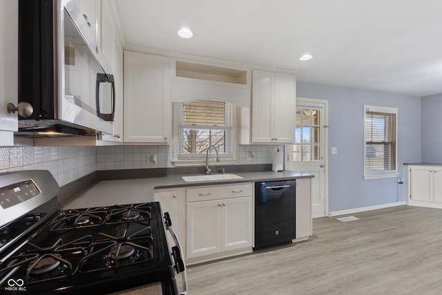 kitchen with black appliances, white cabinets, sink, light hardwood / wood-style flooring, and a healthy amount of sunlight