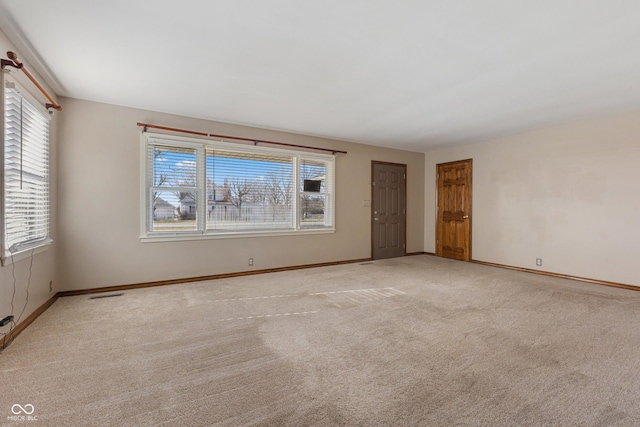 spare room featuring light carpet