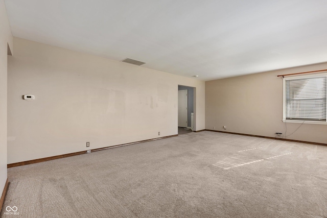 unfurnished room with light carpet