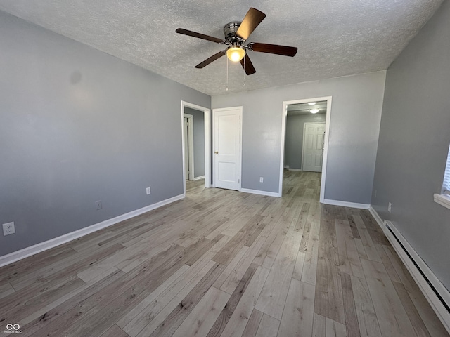 unfurnished bedroom featuring ceiling fan, a baseboard radiator, a textured ceiling, and light wood-type flooring