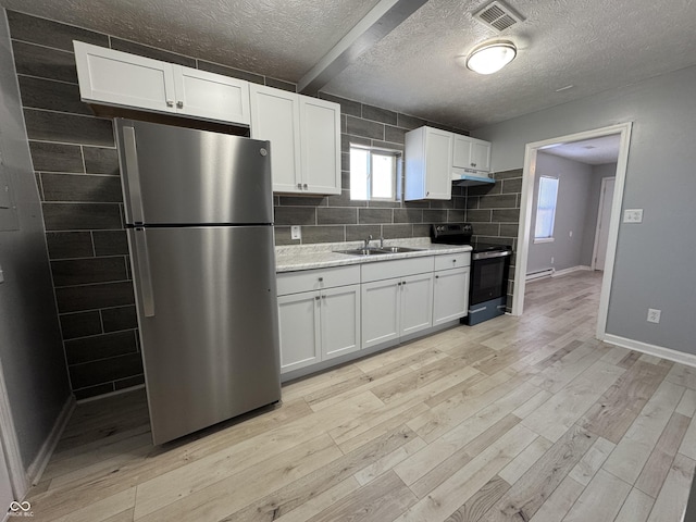 kitchen featuring black range with electric cooktop, white cabinetry, stainless steel refrigerator, and sink