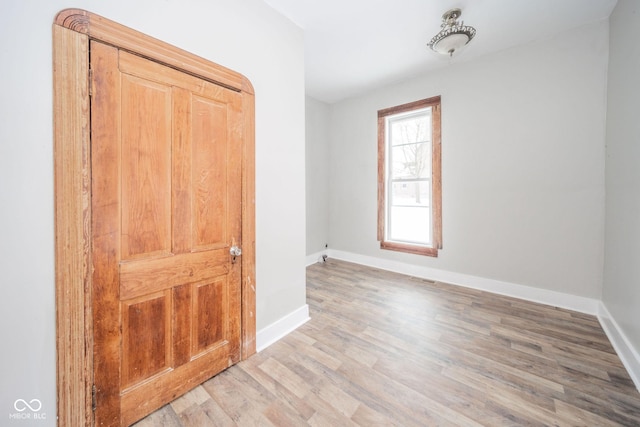 unfurnished room with wood-type flooring